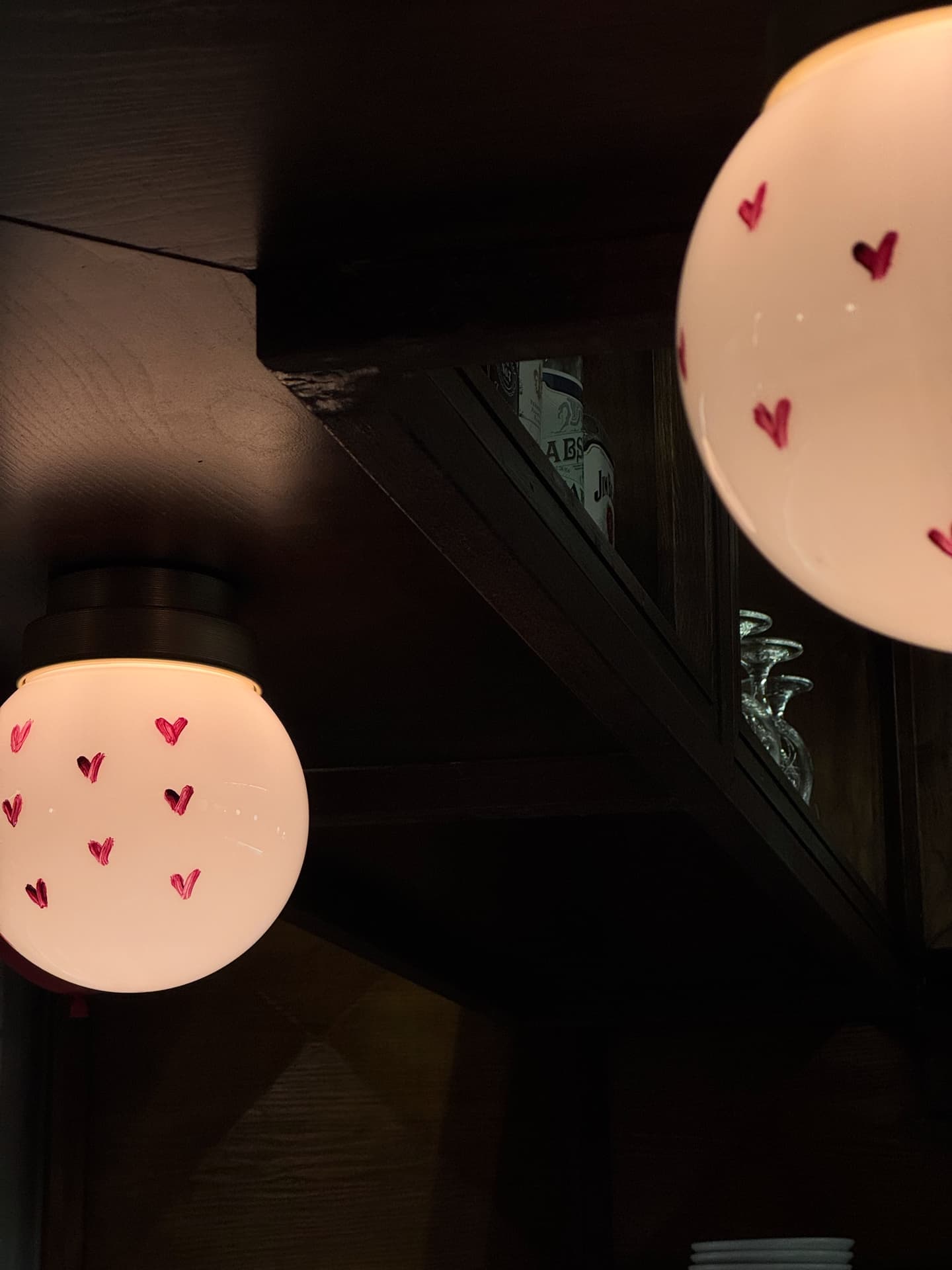 Detail of lights with drawn hearts inside Holy Burger in Porto.