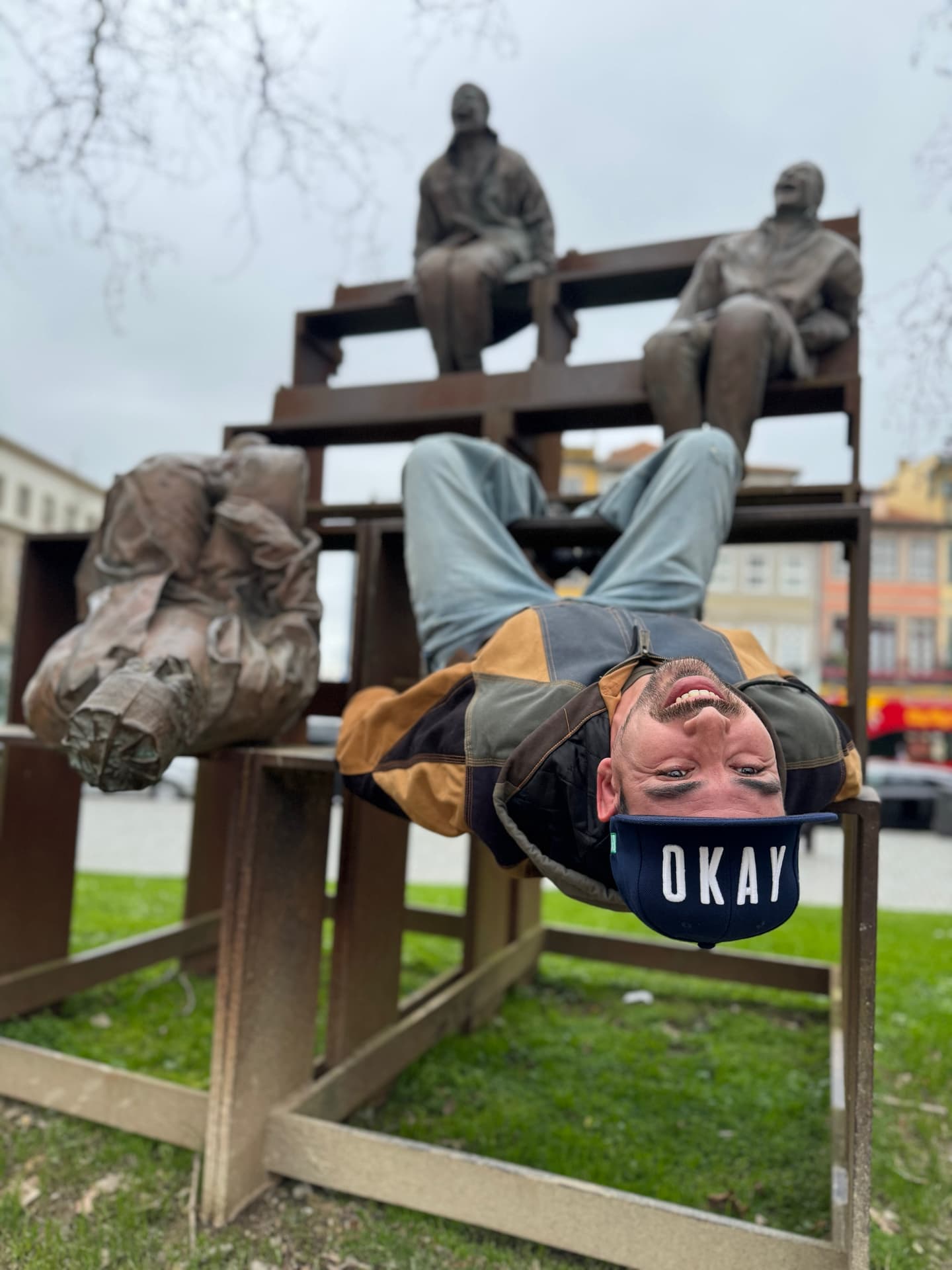 Posing with 3 statues of men laughing in Porto.
