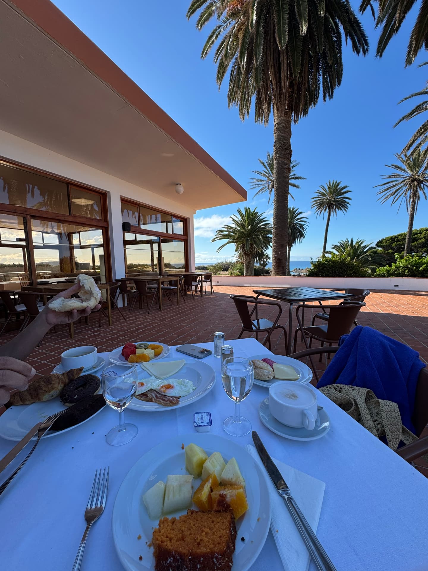 Having breakfast in the Hotel with a gorgeous view for the garden with the ocean in the background.